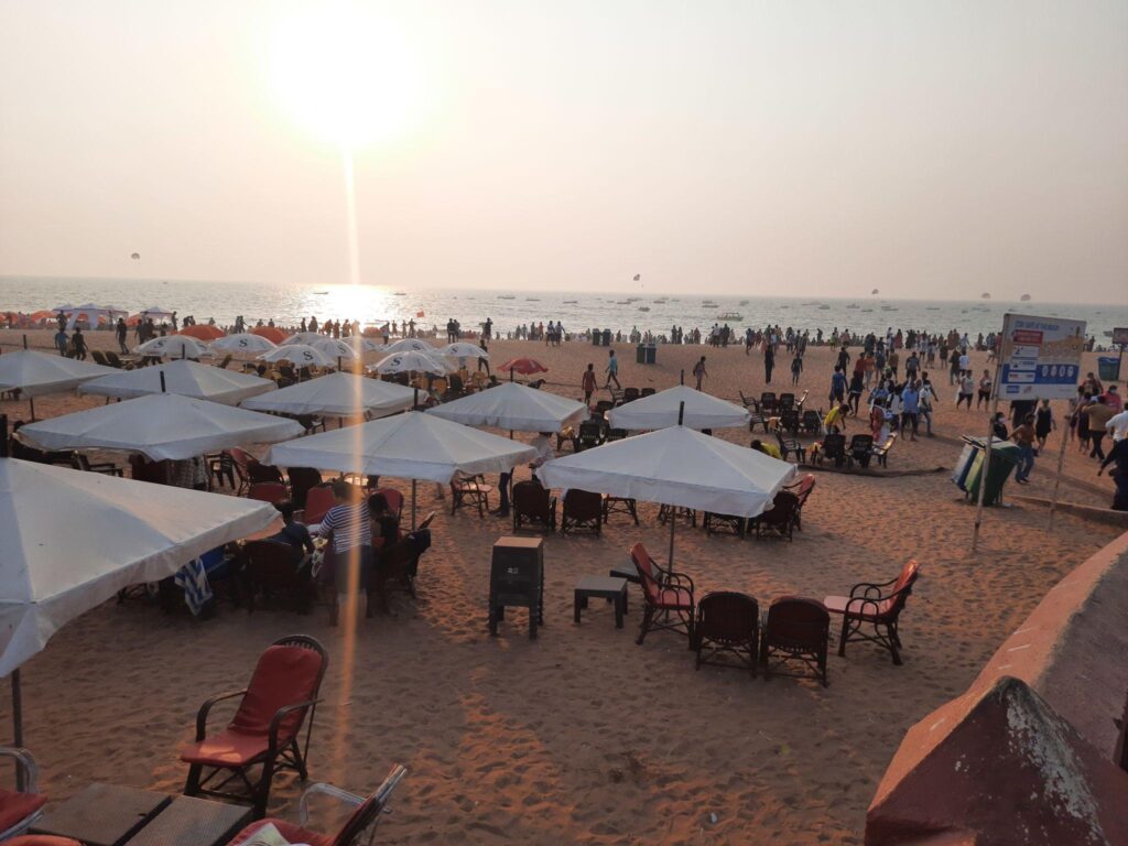 Calangute beach. Cafes and Lounges on the Calangute beach in goa, Tourists relax on the sun loungers by the beach café at sunset.